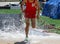 Runner splashing exiting the water of the steeplechase during a track race