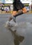 Runner splashing water on the street