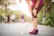 Runner sport knee injury. Woman in knee pain while running work out in park. Health care concept