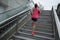 Runner sportswoman climbing up city stairs