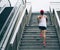 Runner sportswoman climbing up city stairs