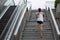 Runner sportswoman climbing up city stairs