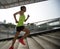 Runner sportswoman climbing up city stairs jogging and running