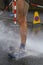 Runner washing mud from legs