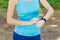Runner woman arms with heart rate monitor, fitness woman checking her smartwatches.