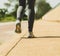 Runner woman feet running on  footpath by the road closeup on shoe. female fitness athlete jogger workout in wellness concept at s
