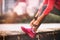 Runner woman getting ready to run tying running shoes laces. Healthy lifestyle jogging motivation closeup of feet or