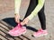 Runner woman lacing trainers shoes