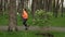 Runner woman running in the rainy city park, side view. Sporty fitness female doing running exercises outdoor. Athlete jogging on