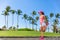 Runner woman stretching leg doing warm-up exercise. Legs stretches exercises before run in summer city park. Healthy