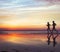 Runners on the beach, silhouette of people jogging at sunset, healthy lifestyle