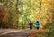 Runners on fall trail through woods