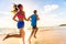 Runners fitness couple running training on beach. Morning cardio workout people doing exercise. ctive sports lifestyle