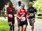 Runners on a path in the woods racing a 10K