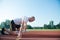 Runners preparing for race at starting blocks