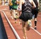 Runners racing on indoor track from behind