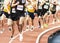 Runners racing the mile on an indoor track