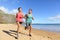 Runners running on beach - jogging couple