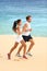 Runners running on beach - jogging couple