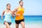 Runners running on beach - jogging couple