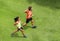 Runners running people healthy fitness couple jogging together on grass park view from above with run partner. Summer