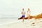 Runners. Young couple running on beach