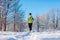 Running athlete woman sprinting in winter forest. Training outside in cold snowy weather