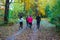 Running athletes in the park on a run in the early morning. Several children are running in the woods doing sports