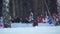 Running biathlon athletes in defocus on background of falling snow Slow motion