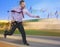 Running businessman in a hurry on blurred background