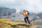 Running caucasian man with backpack and trekking poles by Makalu Barun Park route near Khare. Mera peak climbing acclimatization