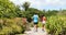 Running couple jogging on park path exercising on beautiful summer day