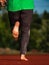 Running female bare feet in long leggings. Mature woman  runs