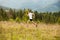 Running fitness man sprinting outdoors with beautiful mountains landscape on background. Caucasian sport male runner training for