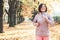 Running girl portrait in atumn park