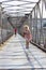 Running little girl on pedestrian bridge