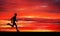 Running man on apocalyptic sunset sky