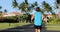 Running man jogging on road exercising on residential street on summer day