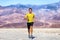 Running man - sprinting athlete runner in summer desert nature landscape background. Wearable tech smartwatch device