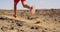 Running man trail running in desert - male athlete running fast