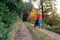 Running mother with stroller enjoying motherhood at autumn sunset