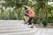 Running pair exercising outside in the city in an urban living active sport photo, with buildings in the background