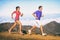 Running people - Runners training outdoor. Young sports athletes couple sprinting as part of healthy lifestyle. Fit