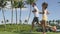 Running People. Slow motion video of multiethnic young couple jogging in park. Full length of man and woman are in