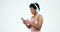 Running, phone and woman with headphones on a white background for workout, training and exercise. Fitness, sports and