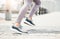 Running shoes, feet sneakers and city cardio exercise, marathon and sports training in urban outdoor. Closeup woman