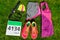 Running shoes, marathon race bib number, runners gear and energy gels on grass background, sport, fitness