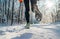 Running shoes sole close up image of winter jogger feet in running sneakers on the snowy park path during sunny day. Rear view