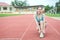 Running shoes - woman tying shoe laces. Female sport fitness runner getting ready for jogging outdoors on the lanes of a track