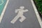 Running sign in running track on asphalt road